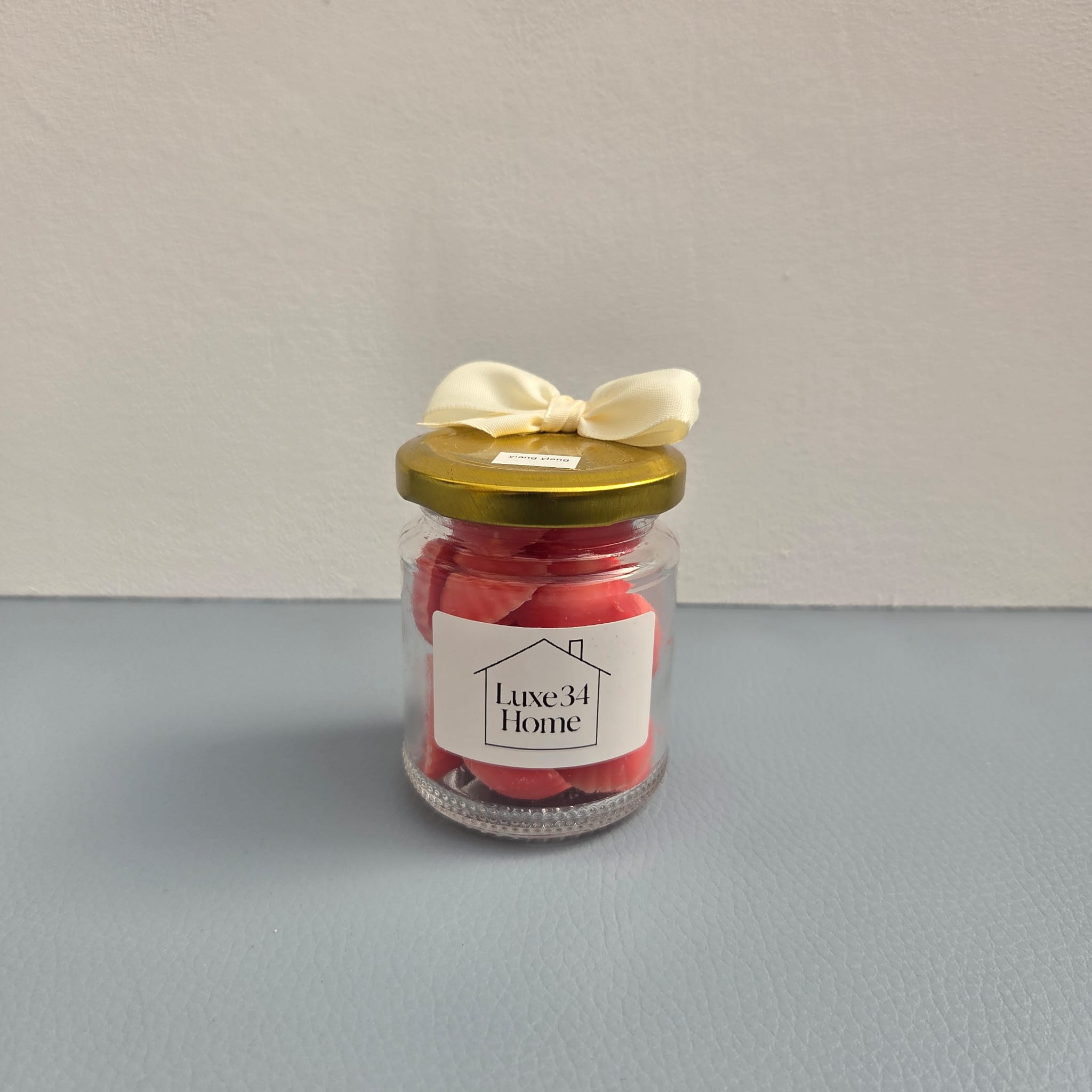 Luxe 34 Home ylang ylang wax melts in glass jar with gold lid and cream ribbon bow