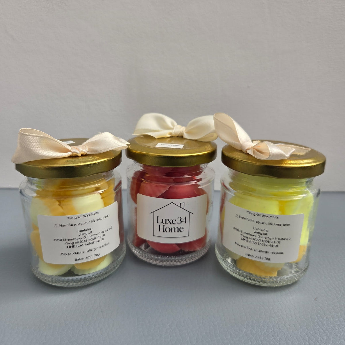 Three Luxe 34 Home wax melt jars including ylang ylang showing the range