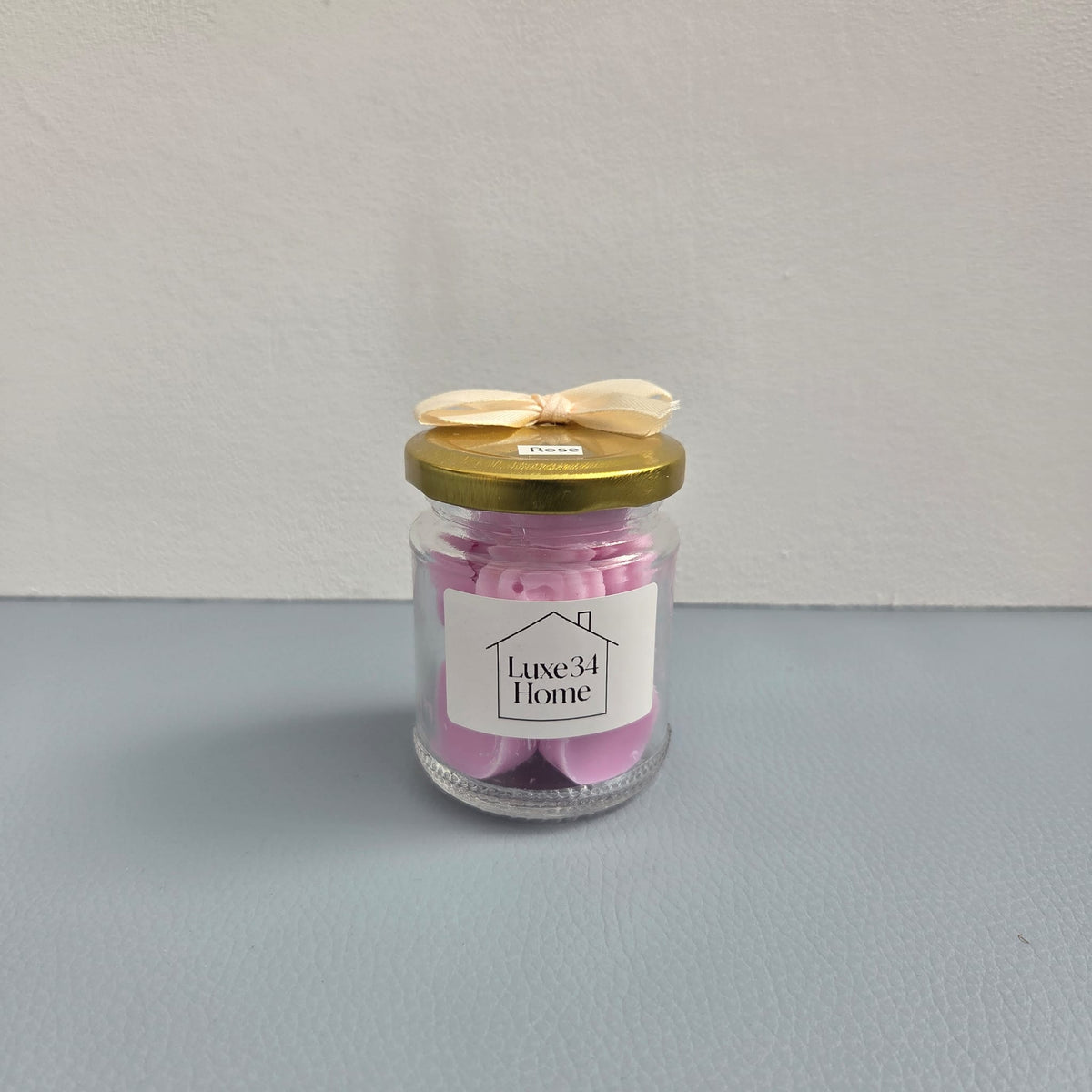 Luxe 34 Home rose wax melts in glass jar with pink wax melts, gold lid and cream ribbon bow
