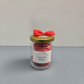 Luxe 34 Home cinnamon wax melts in glass jar with deep red wax melts, gold lid and red ribbon bow